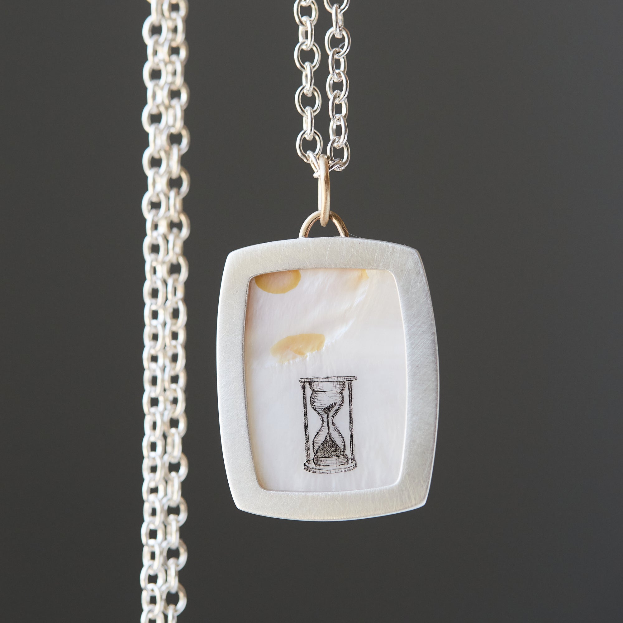 Hand drawn hourglass scrimshaw on mother of pearl - necklace