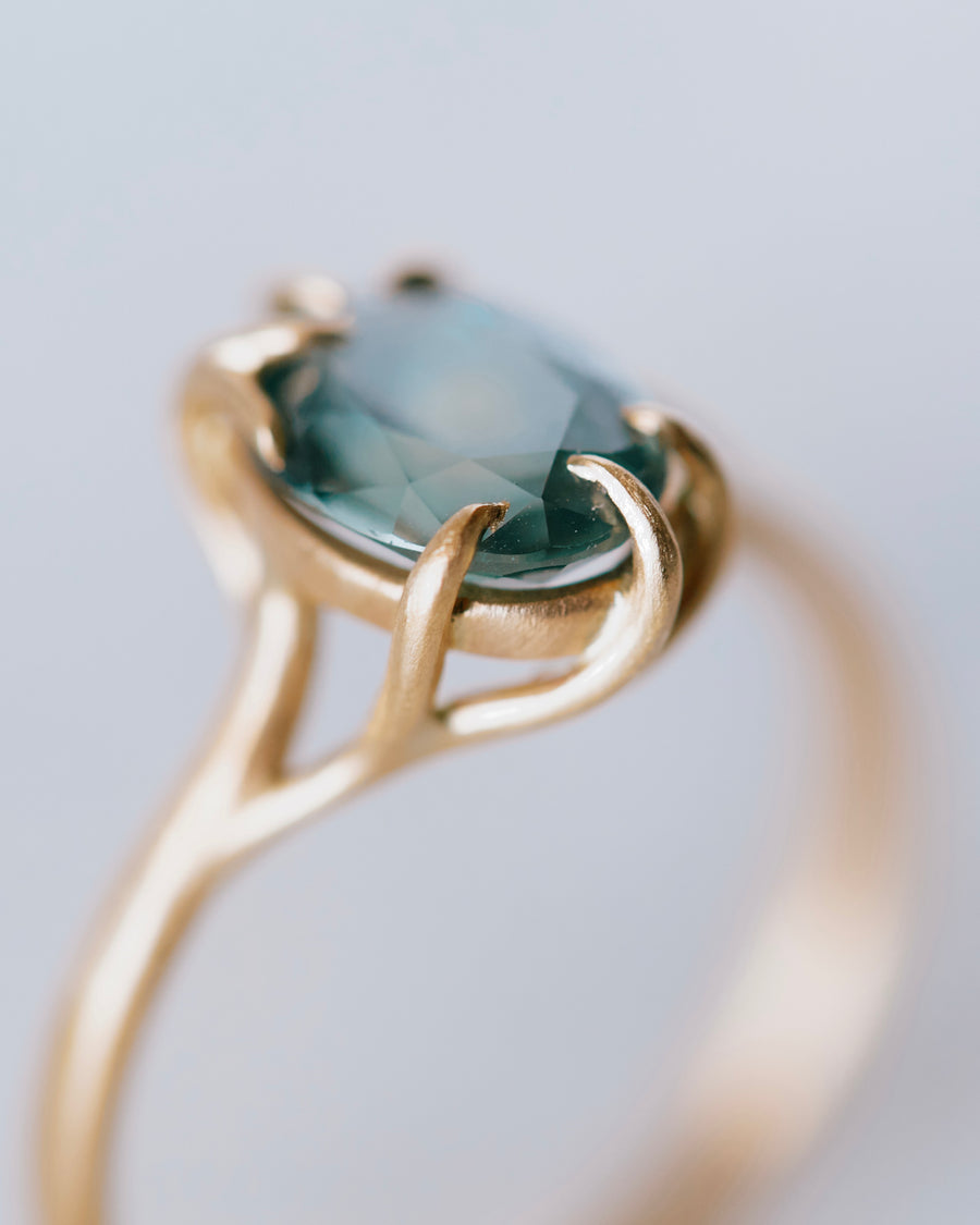 Hannah Blount waiting gold rings with blue montana sapphire stone.