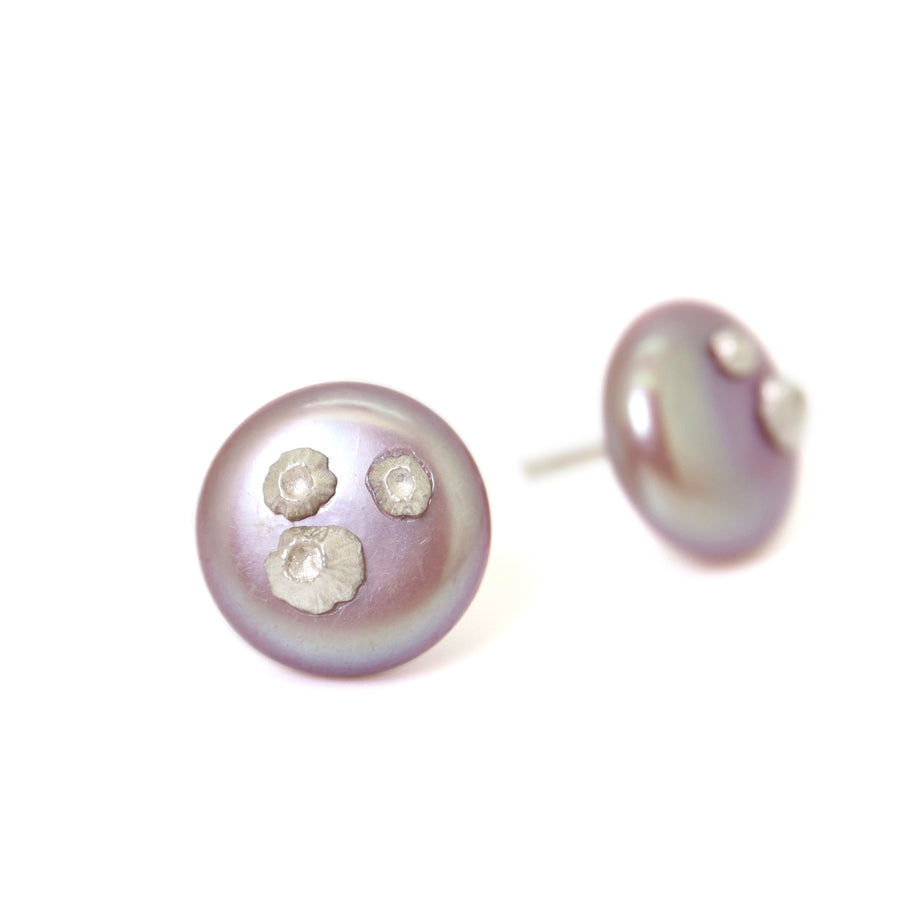 front and side view of large pink freshwater button pearl studs with silver barnacles by hannah blount jewelry