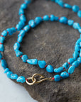 Raw Kingman turquoise necklace with coral-hued silk and gold clasp by Hannah Blount