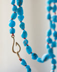 Raw Kingman turquoise necklace with coral-hued silk and gold clasp by Hannah Blount