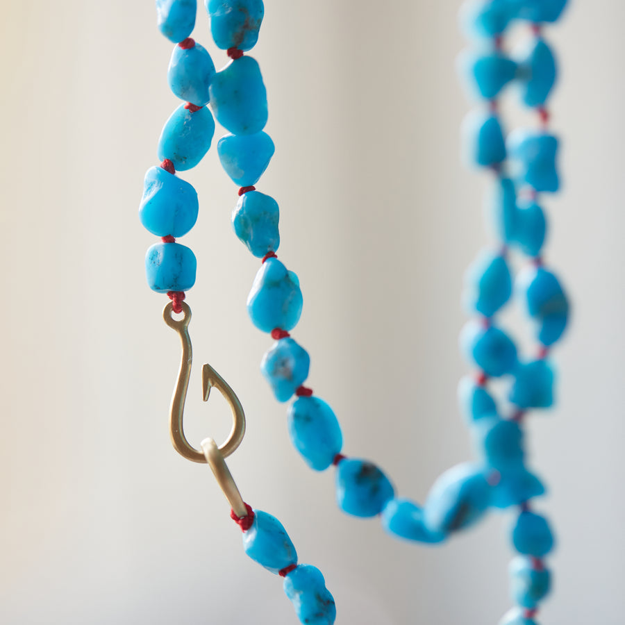 Raw Kingman turquoise necklace with coral-hued silk and gold clasp by Hannah Blount