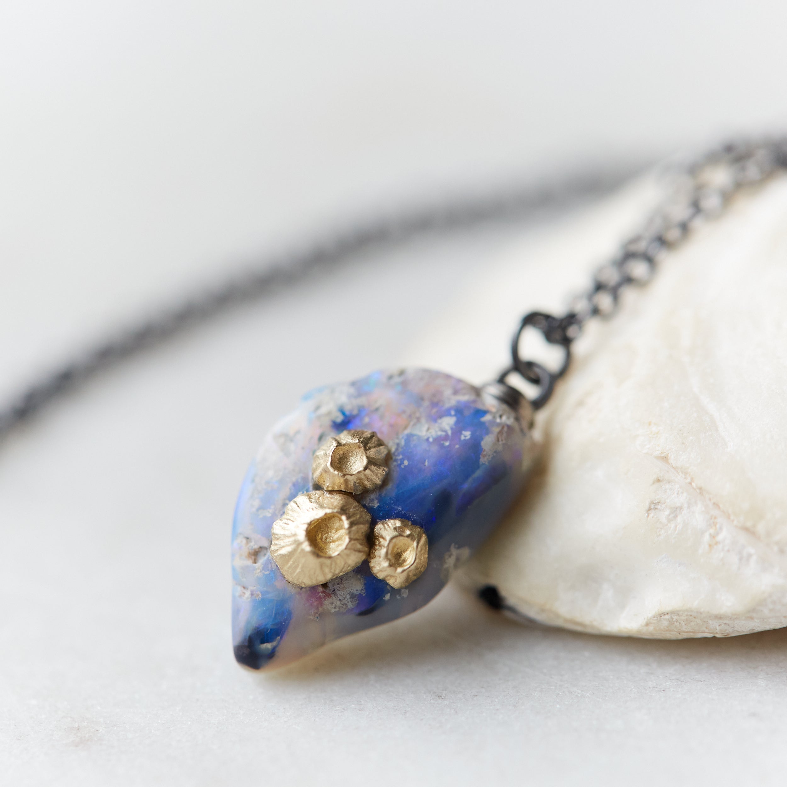 Raw opal with gold barnacles by Hannah Blount