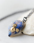 Raw opal with gold barnacles by Hannah Blount