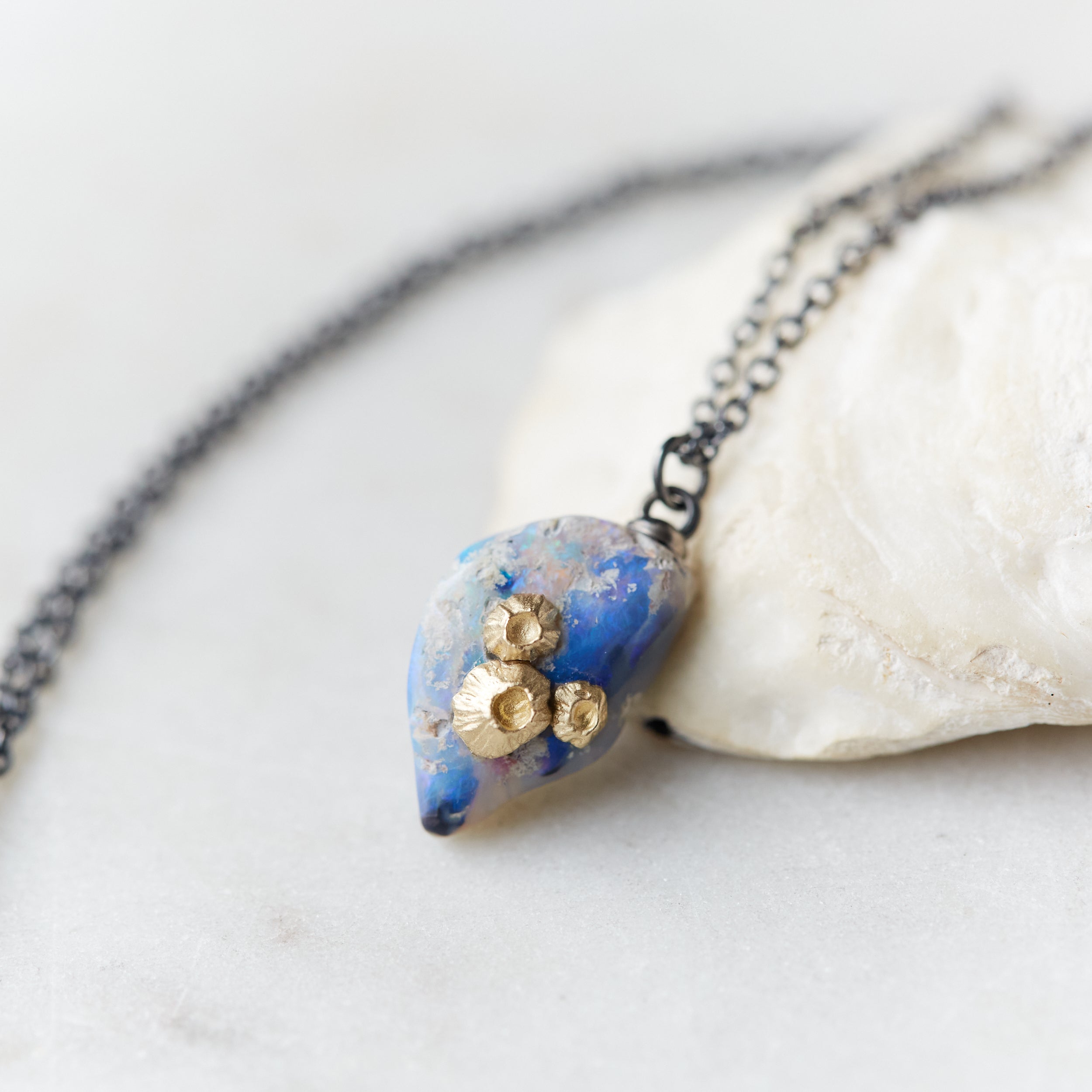 Raw opal with gold barnacles by Hannah Blount