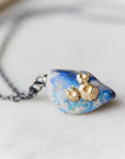 Raw opal with gold barnacles by Hannah Blount