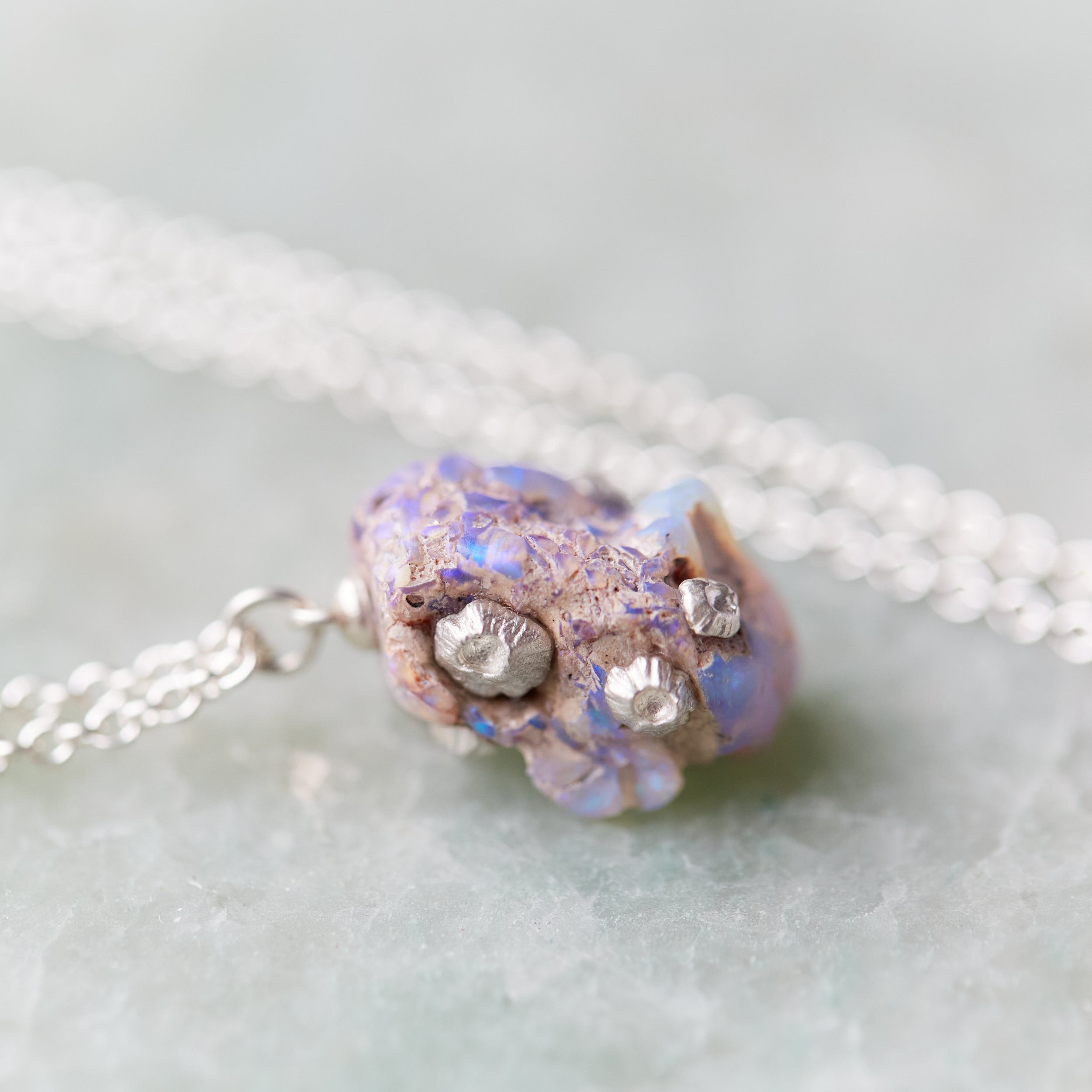 Raw opal silver necklace with barnacles by Hannah Blount