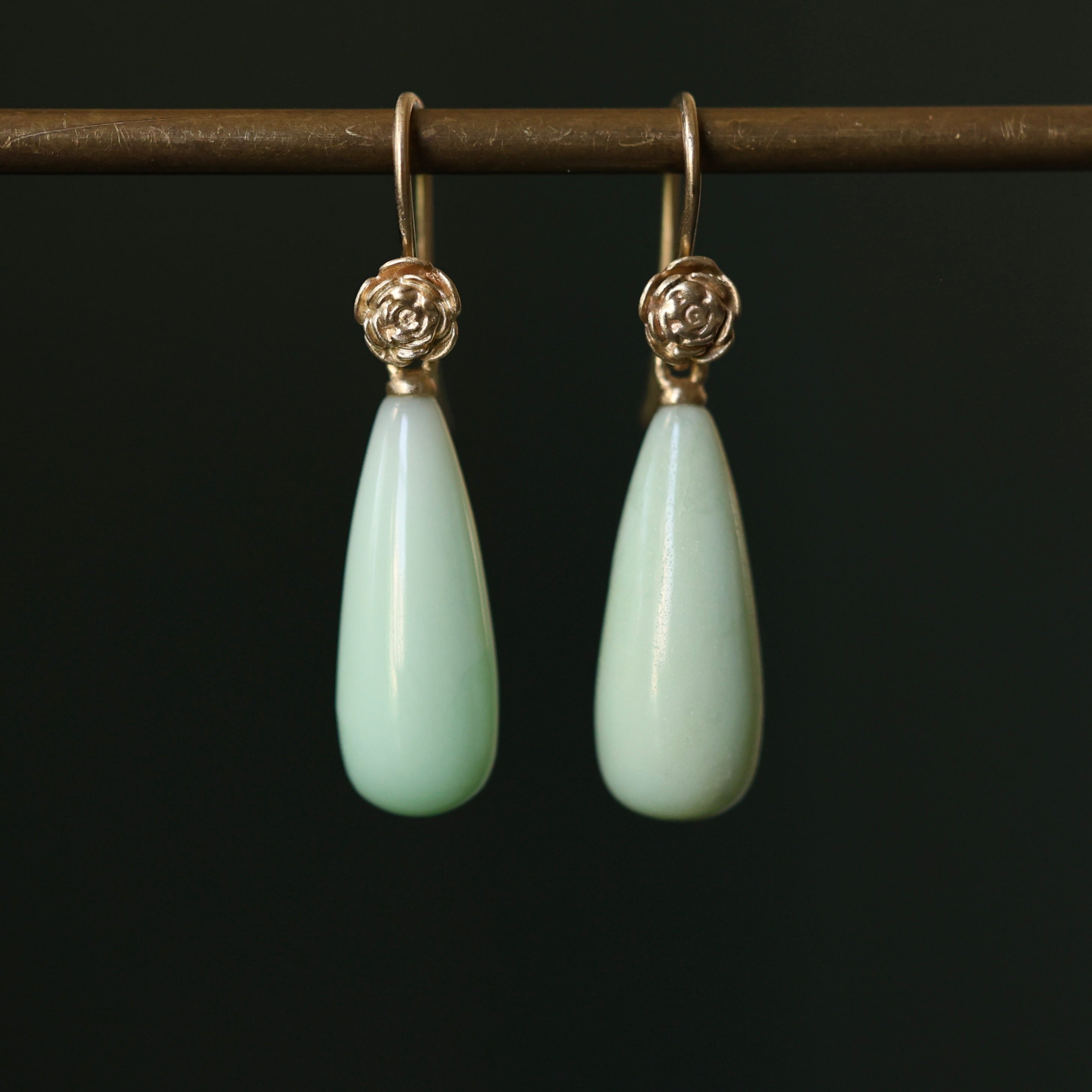 Teardrop shaped chrysoprase earrings with 14k yellow gold rose accents and ear wires. 
