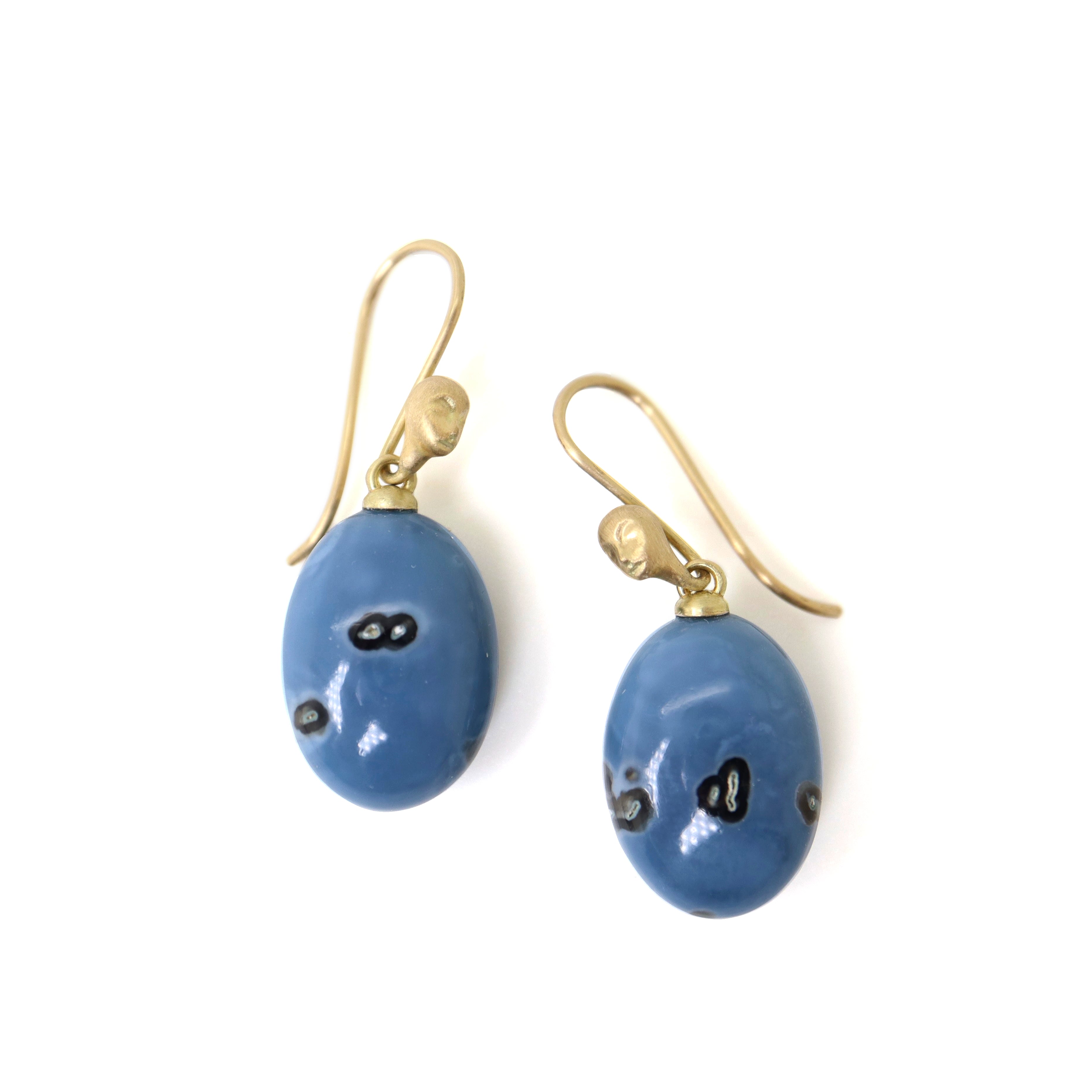mottled blue common opal oval drops set as earrings with ear wires featuring gold Lady faces