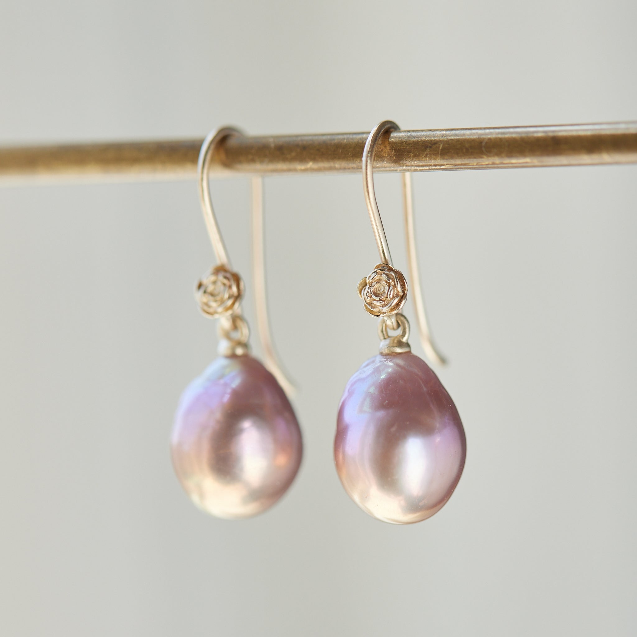 pink pearls hang from gold rose ear wires