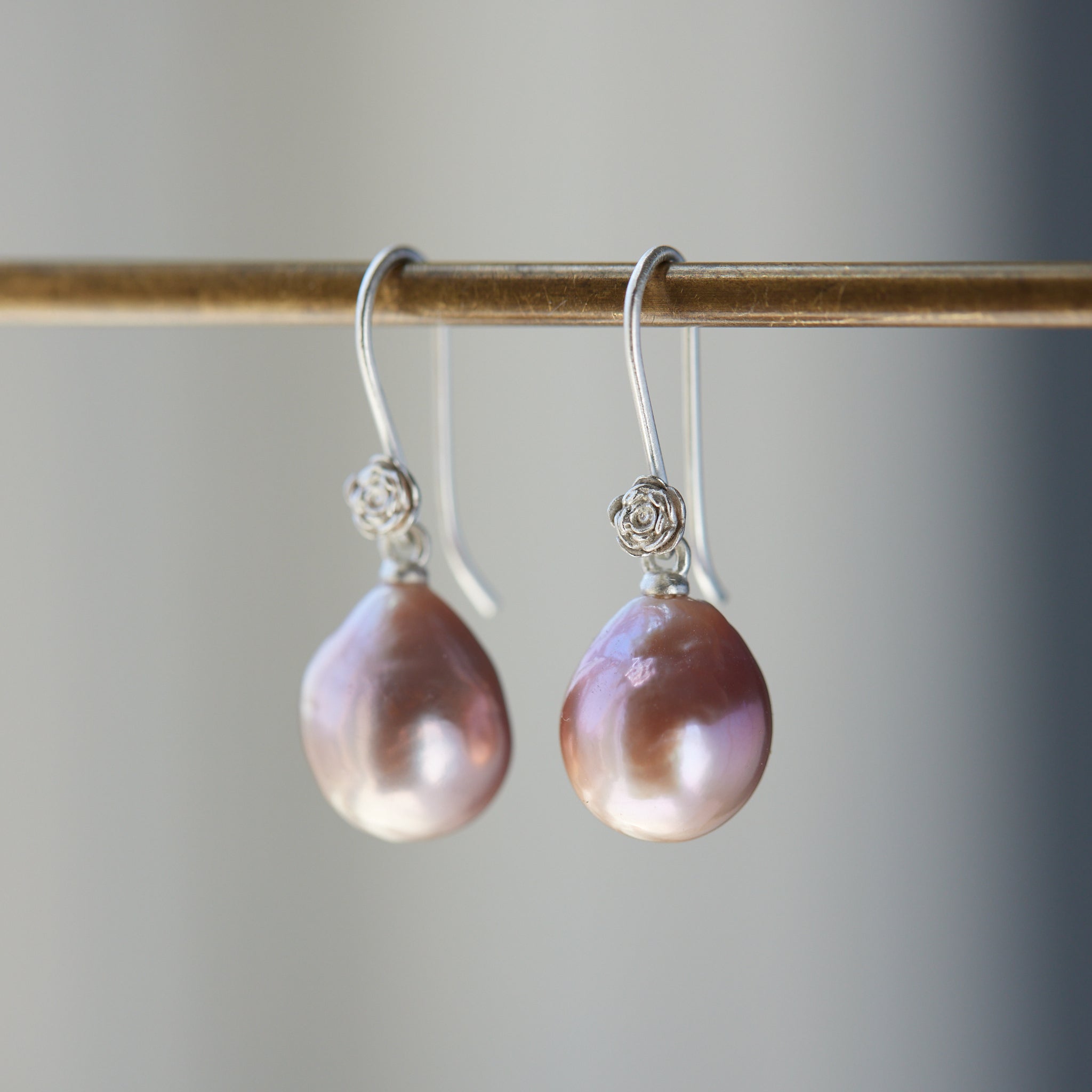 pink pearl drop earrings with bright sterling silver ear wires with rose accents. 