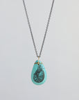 Turquoise teardrop pendant necklace with a nautilus illustration on a light gray background