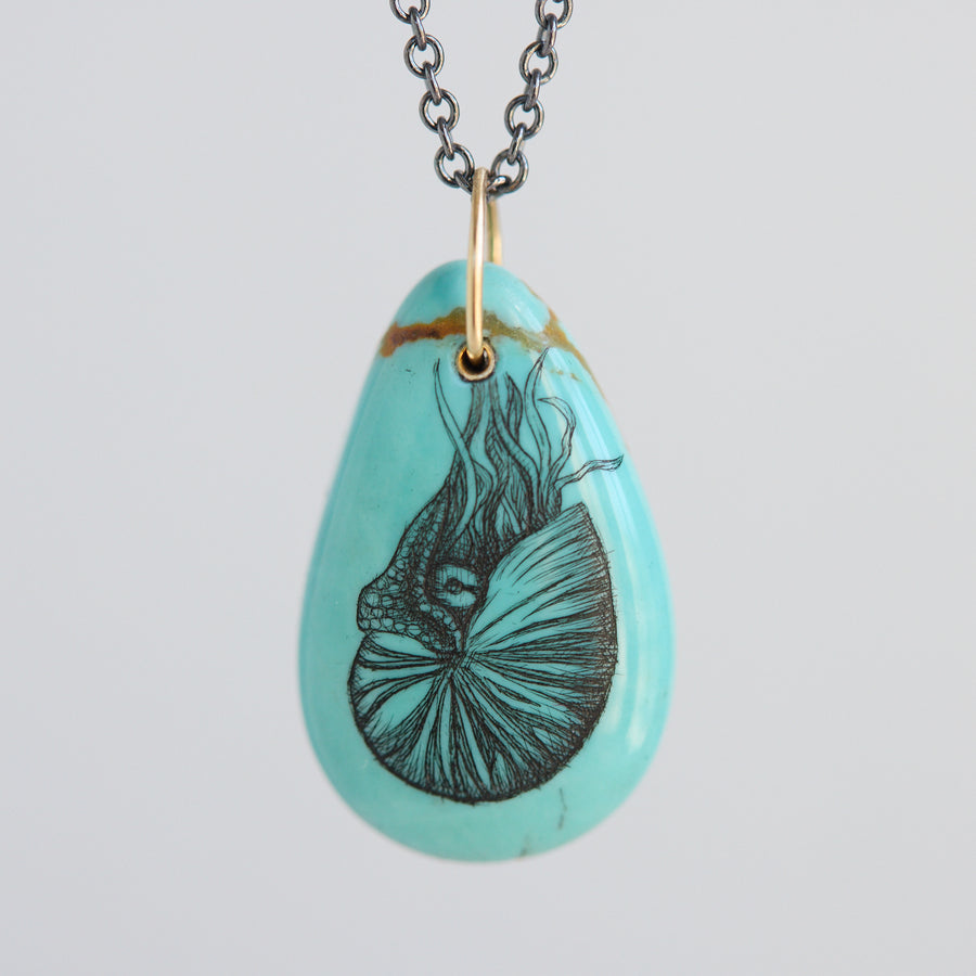 Turquoise teardrop pendant necklace with a nautilus illustration on a light gray background
