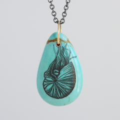 Turquoise teardrop pendant necklace with a nautilus illustration on a light gray background