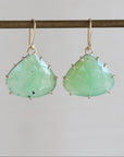 Pair of green teardrop earrings on a thin rod against a light gray background