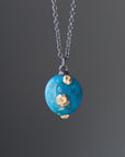 Turquoise pendent necklace with gold barnacles by Hannah Blount