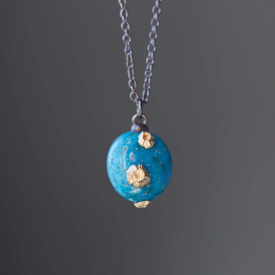 Turquoise pendent necklace with gold barnacles by Hannah Blount