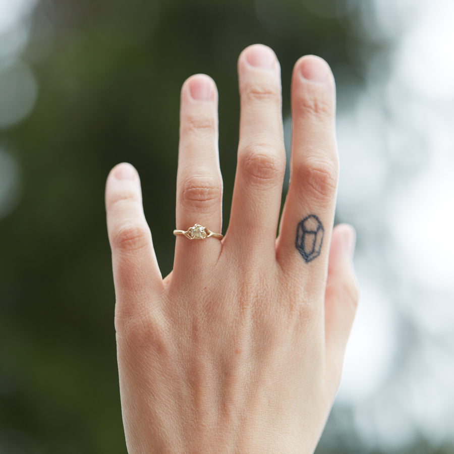 ring of yellow old mine cut diamond set in gold branches on hand by hannah blount