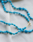 Kingman turquoise double-strand necklace with aloe-hued silk and gold clasp by Hannah Blount