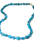 Turquoise beaded necklace with gold barnacles by Hannah Blount