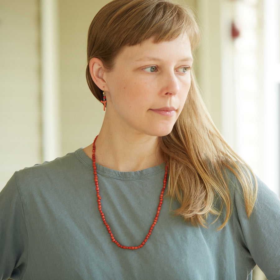 Red coral necklace by Hannah Blount on person