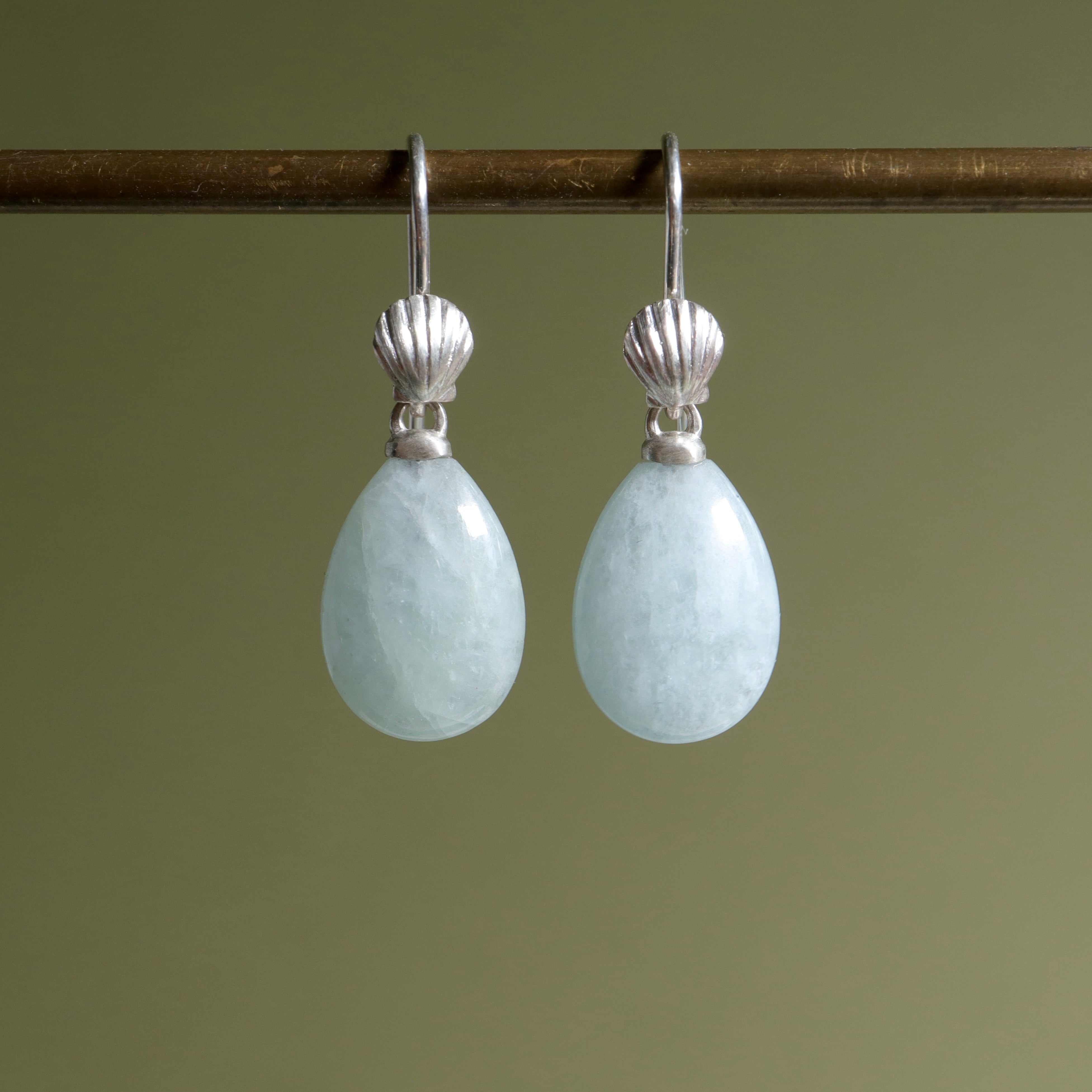 teardrops of pale, icy aquamarine hang beneath little silver scallop shell ear wires