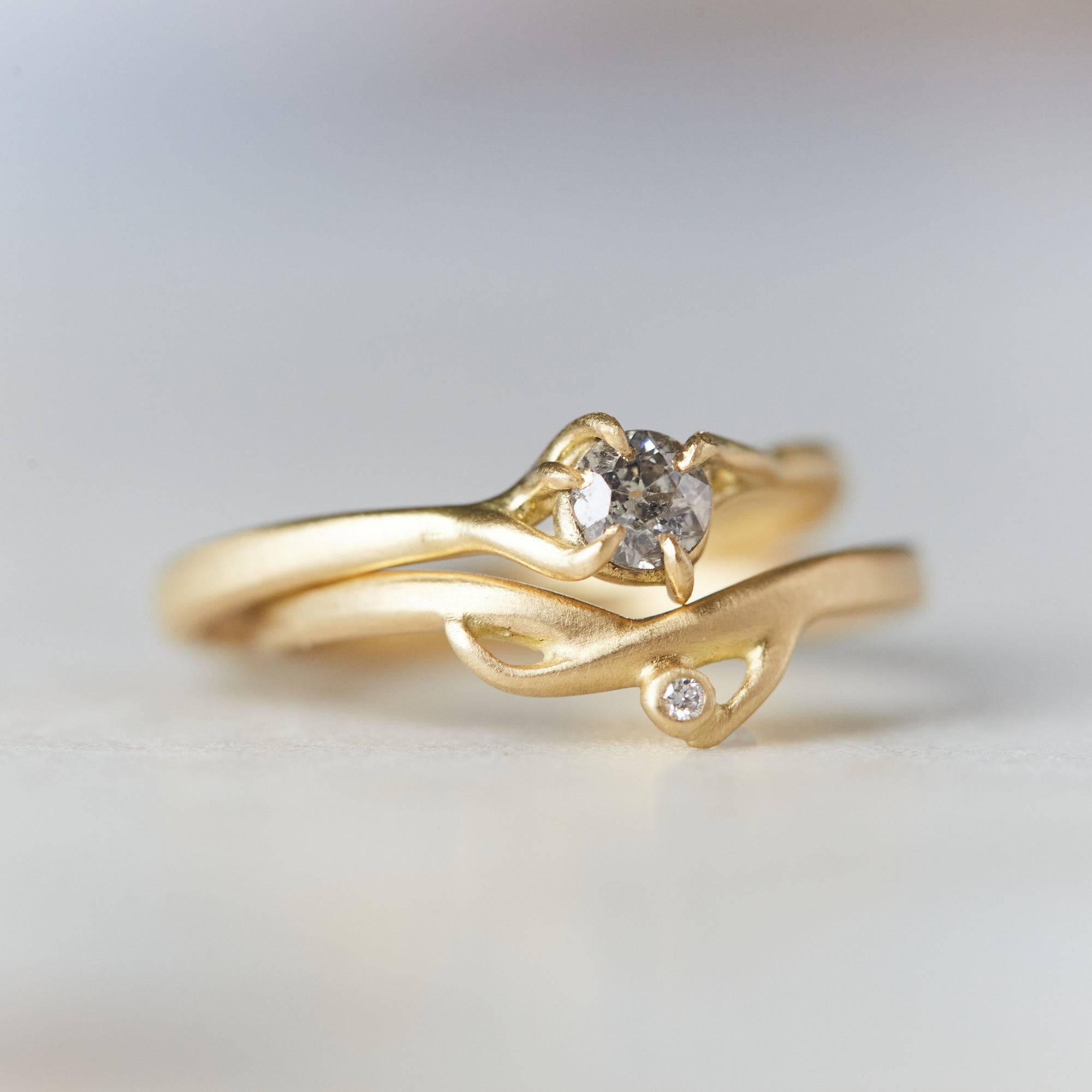 gold branch ring with little salt and pepper diamond, stacked with the little branch waiting ring with diamond. 18k yellow gold.