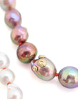 detail of pink and white freshwater baroque pearl necklace in ombre pattern with gold barnacles and fish hook clasp and coral silk by hannah blount jewelry