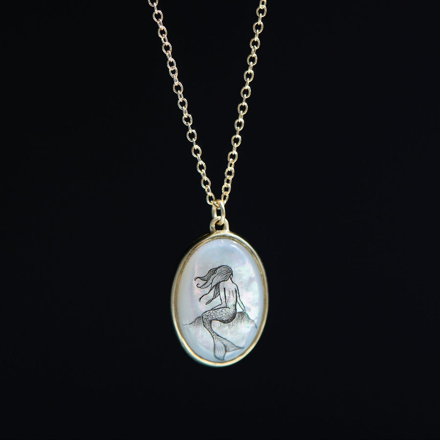 Necklace with a mermaid pendant on a black background