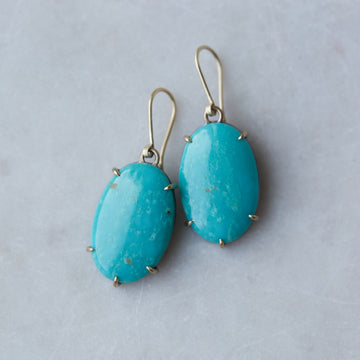 teal kingman turquoise earrings set in gold prongs
