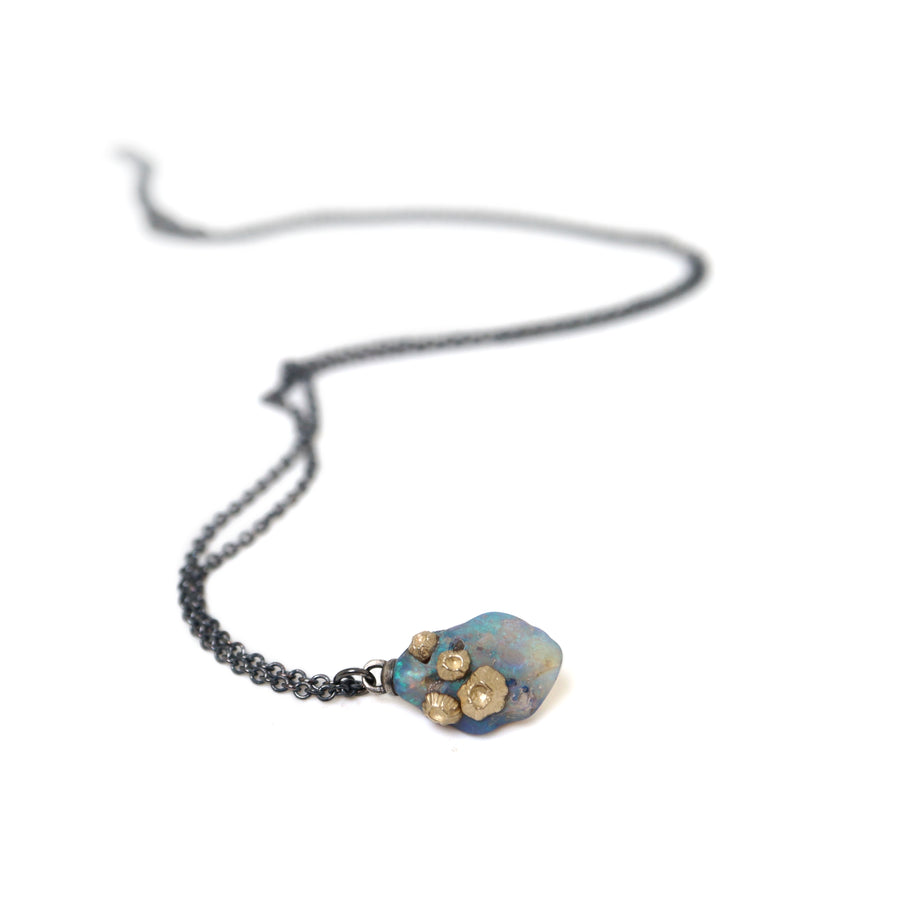 raw fossilized wood opal necklace with nautical gold barnacles and black silver chain