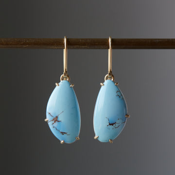 drop earrings of butterfly wing shaped kazakhstan turquoise are set in gold prongs
