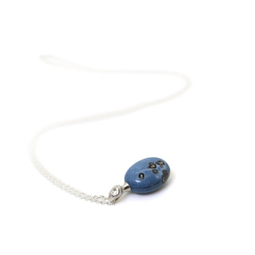 mottled blue common opal set under a silver lady pendant