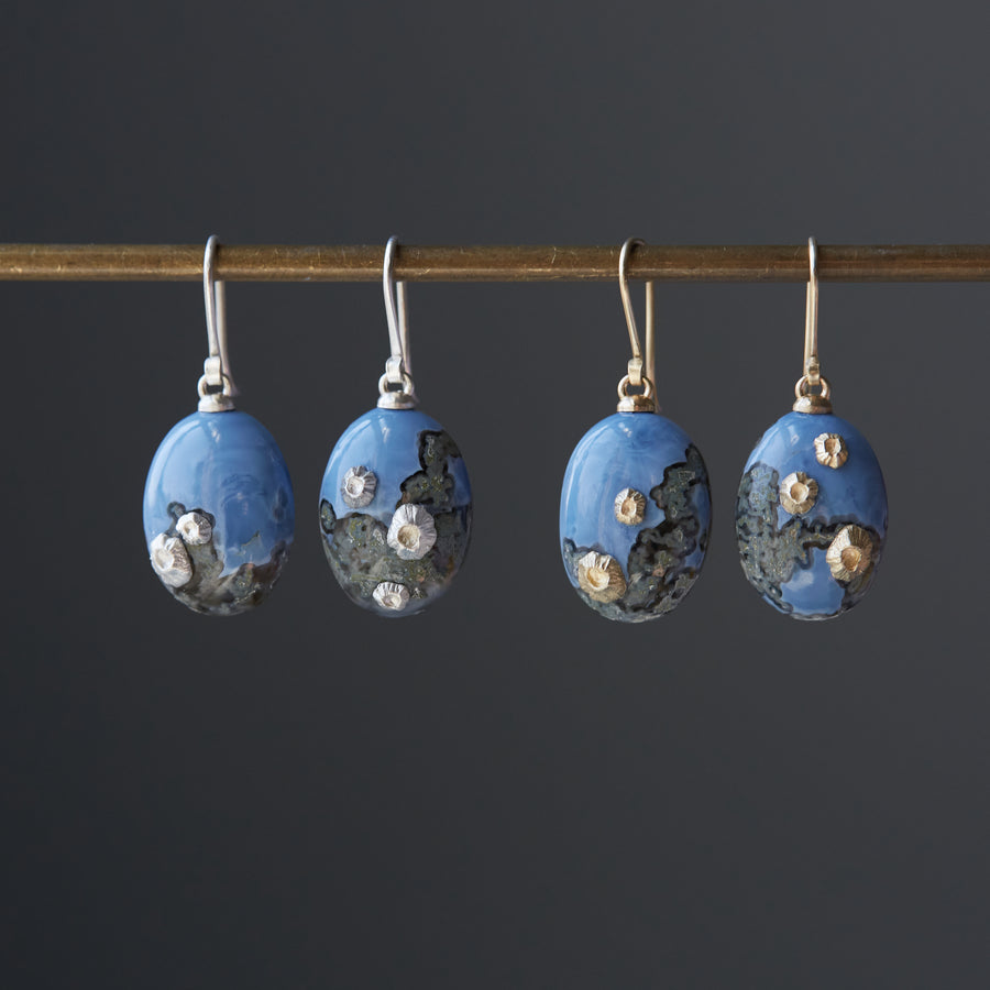 two pairs of mottled blue common opal earrings, one pair with silver barnacles and ear wires and one pair with gold barnacles and ear wires