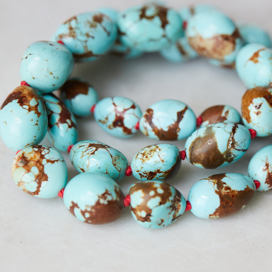 detail of Kingman Turquoise strand with red silk by Hannah Blount