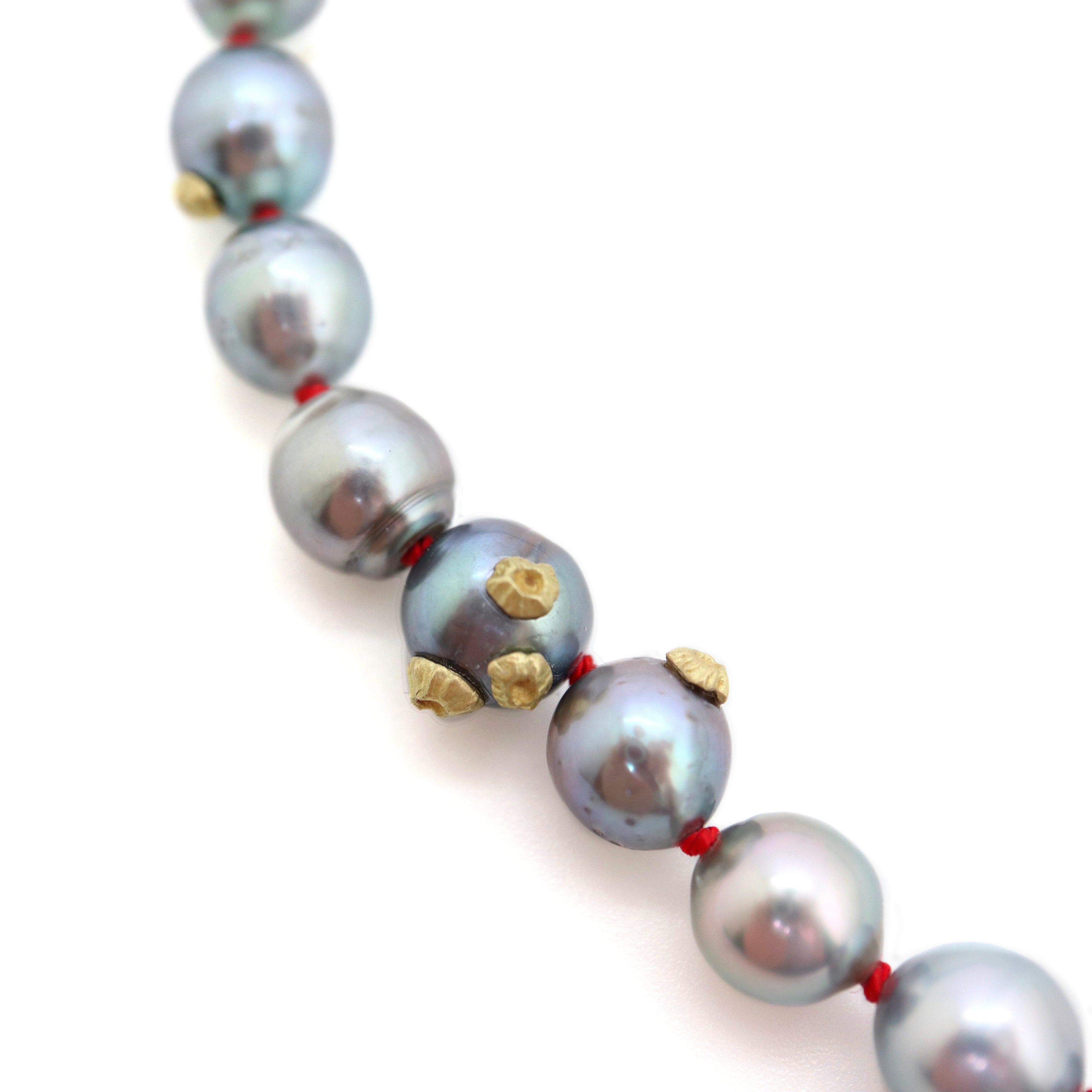 Tahitian black pearls with gold barnacles