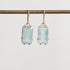 Bright blue stones suspended from gold ear wires