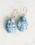 Marbled turquoise earrings held in gold prongs