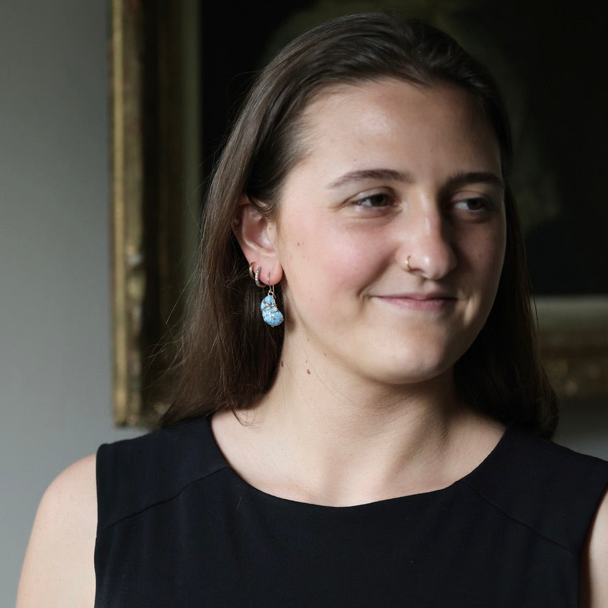 Woman smiling wearing blue turquoise earrings