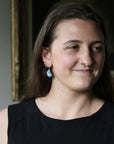 Woman smiling wearing blue turquoise earrings