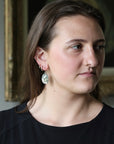 Woman wearing included moss agate earrings