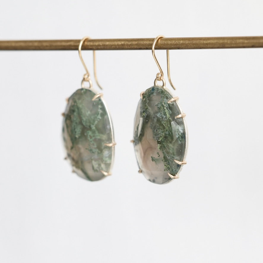 Moss agate earrings held in gold prongs
