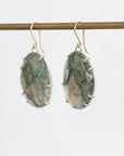 Moss agate earrings held in gold prongs