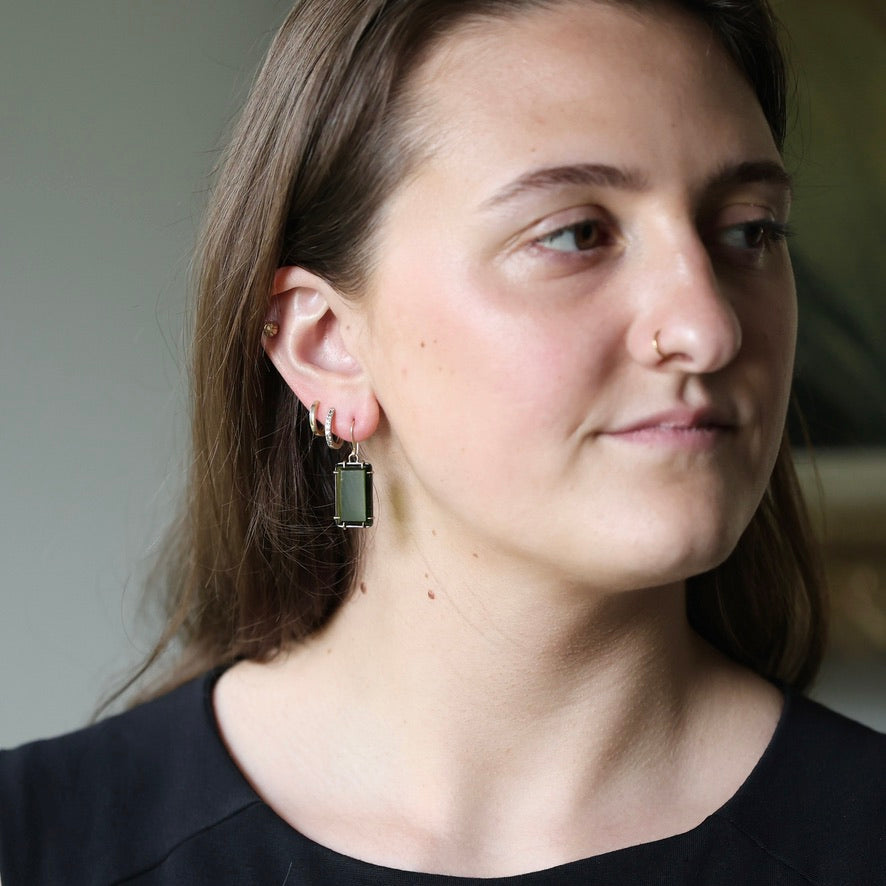 Woman wearing elongated stone earrings