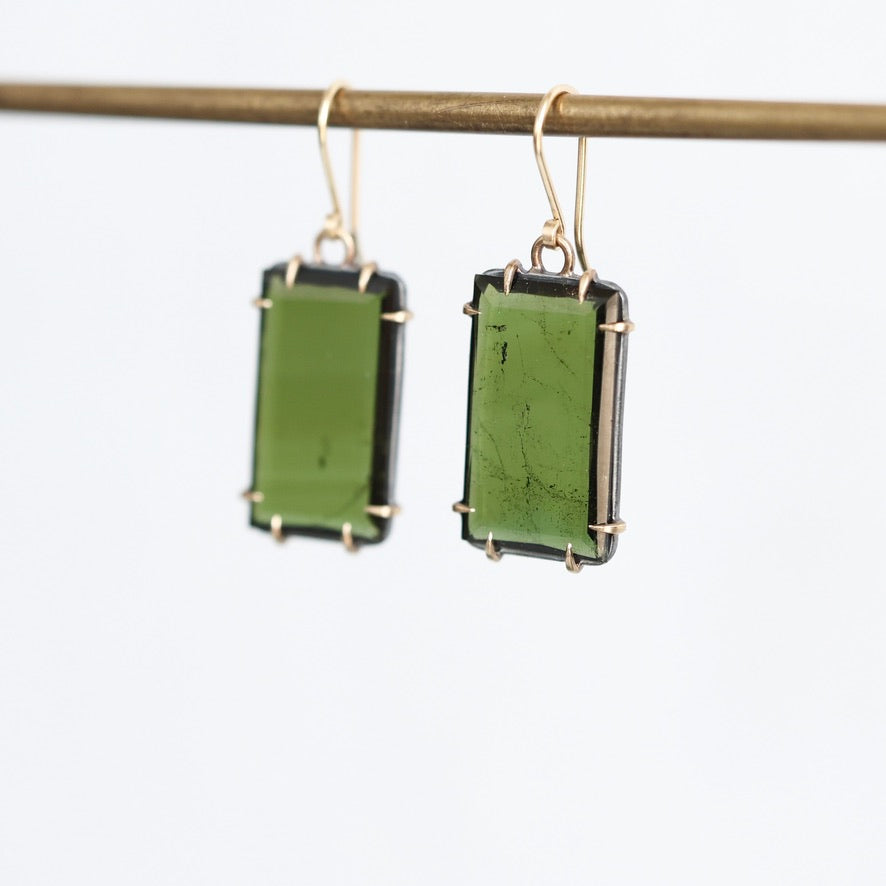 Green stone earrings against white background
