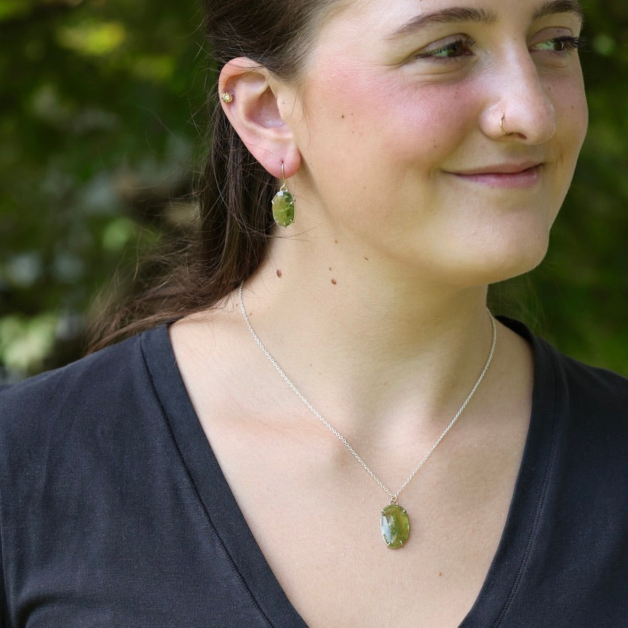 Green gemstone jewelry on woman