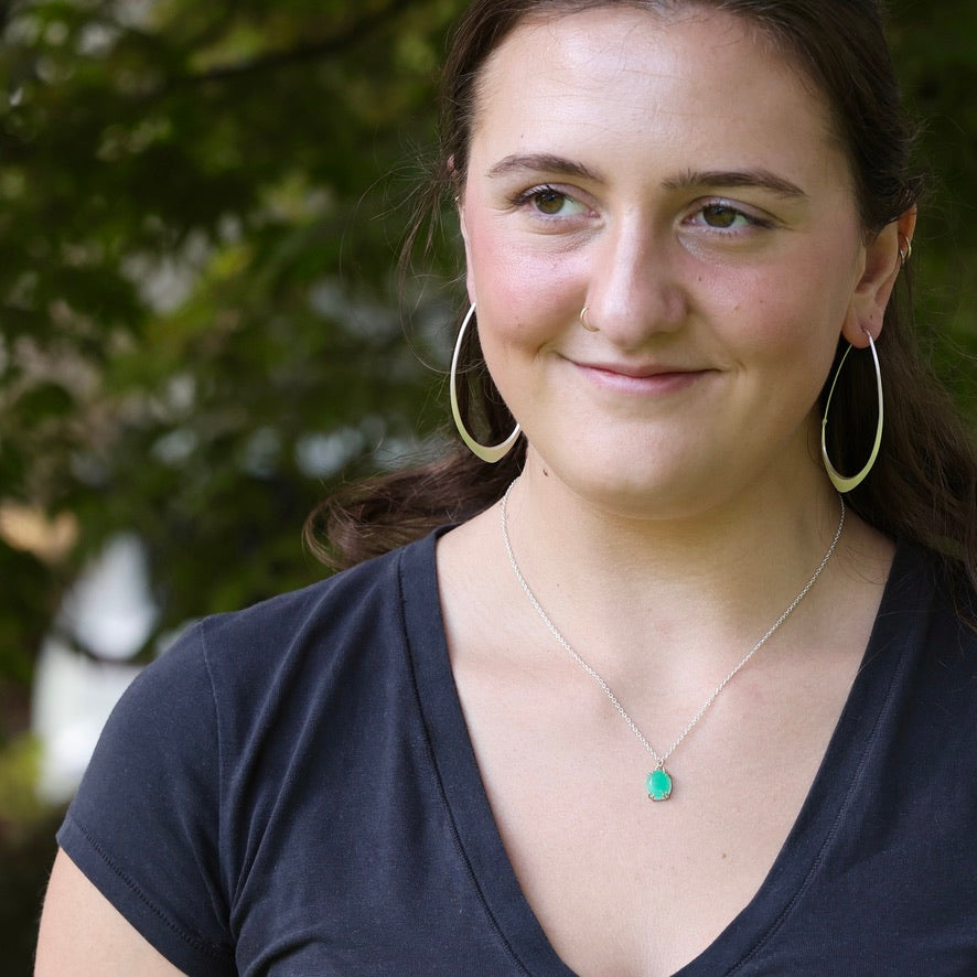 Green gemstone necklace on person