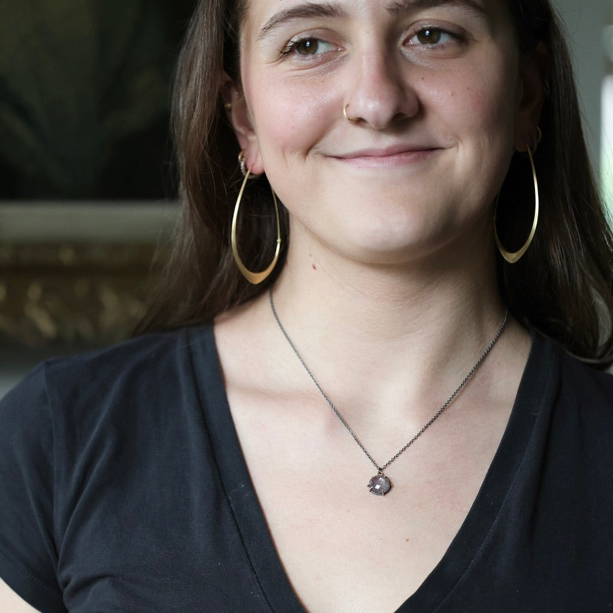 Woman wearing purple necklace pendant 
