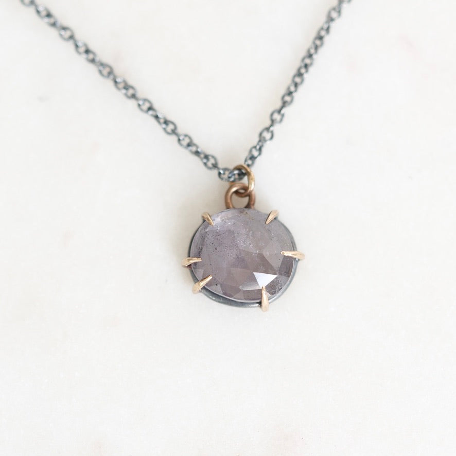 Purple necklace pendant on white background