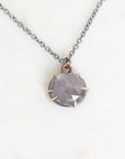 Purple necklace pendant on white background